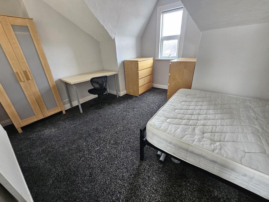A bright and simple bedroom with a single bed, ...