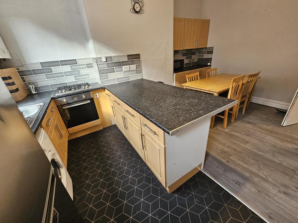 Modern kitchen featuring a spacious countertop,...