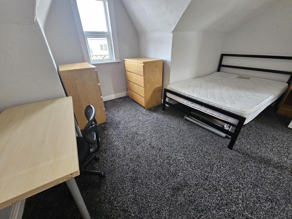 A bright and functional student bedroom featuri...