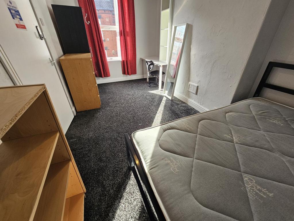 A well-maintained bedroom featuring a mattress ...