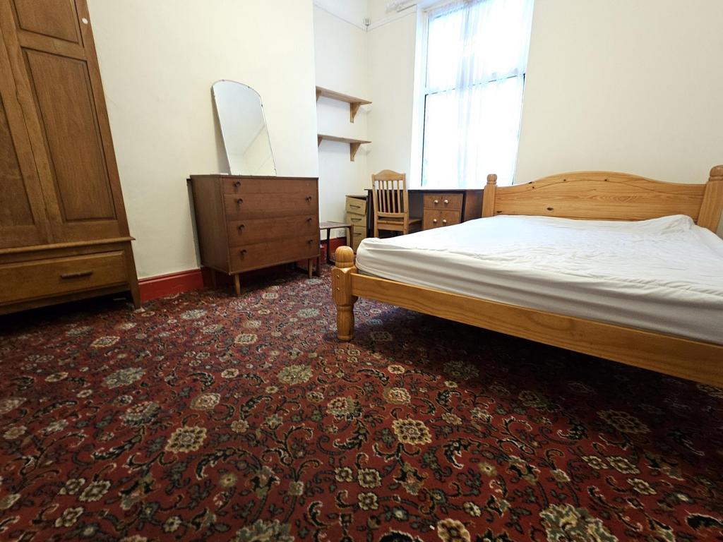 A cozy bedroom featuring a comfortable double b...