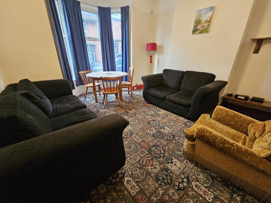 A cozy and well-maintained living room with mul...