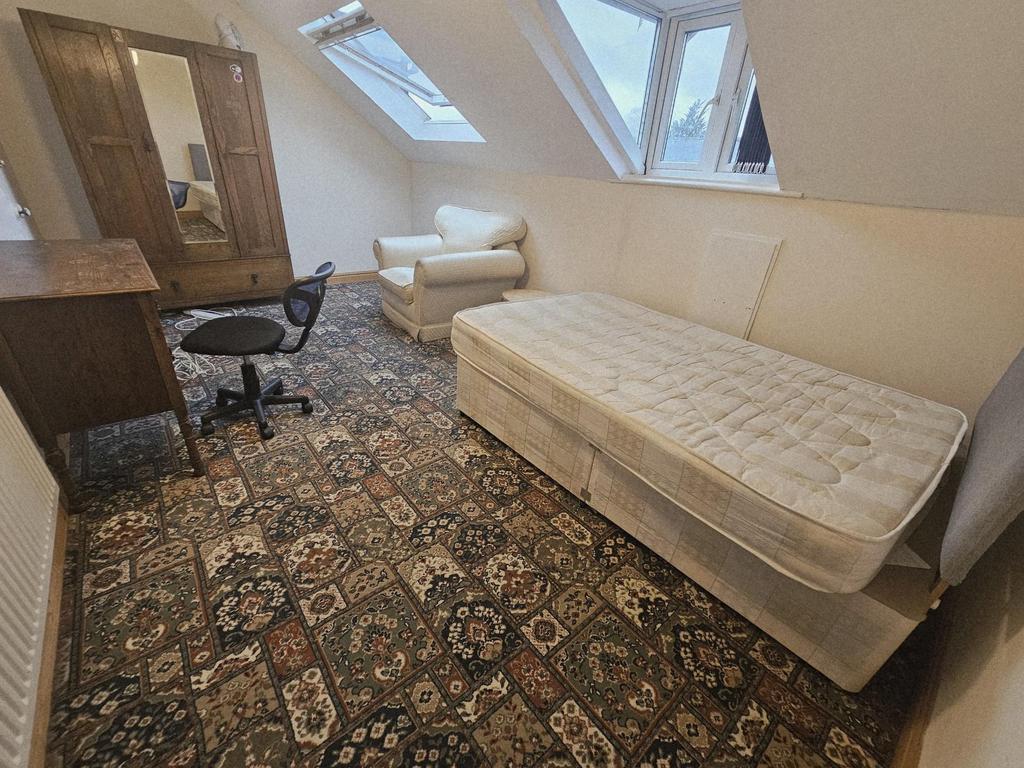 A well-lit living room with a large, comfortabl...