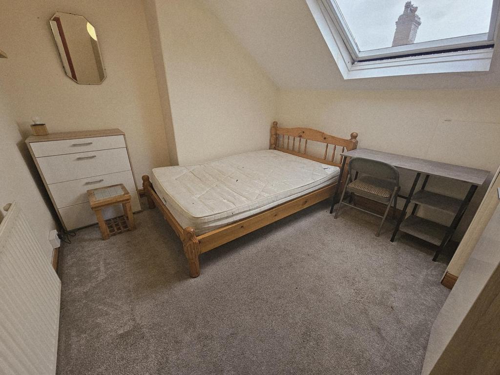 A bright and tidy master bedroom featuring a si...
