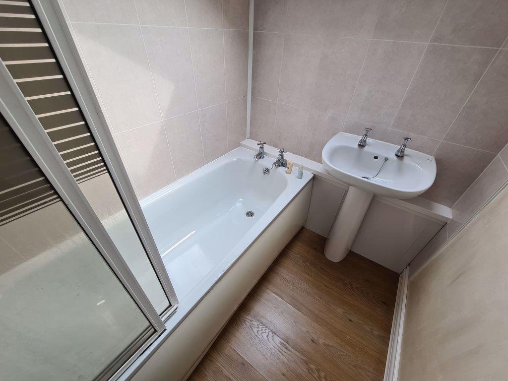 A clean and modern bathroom featuring a white b...