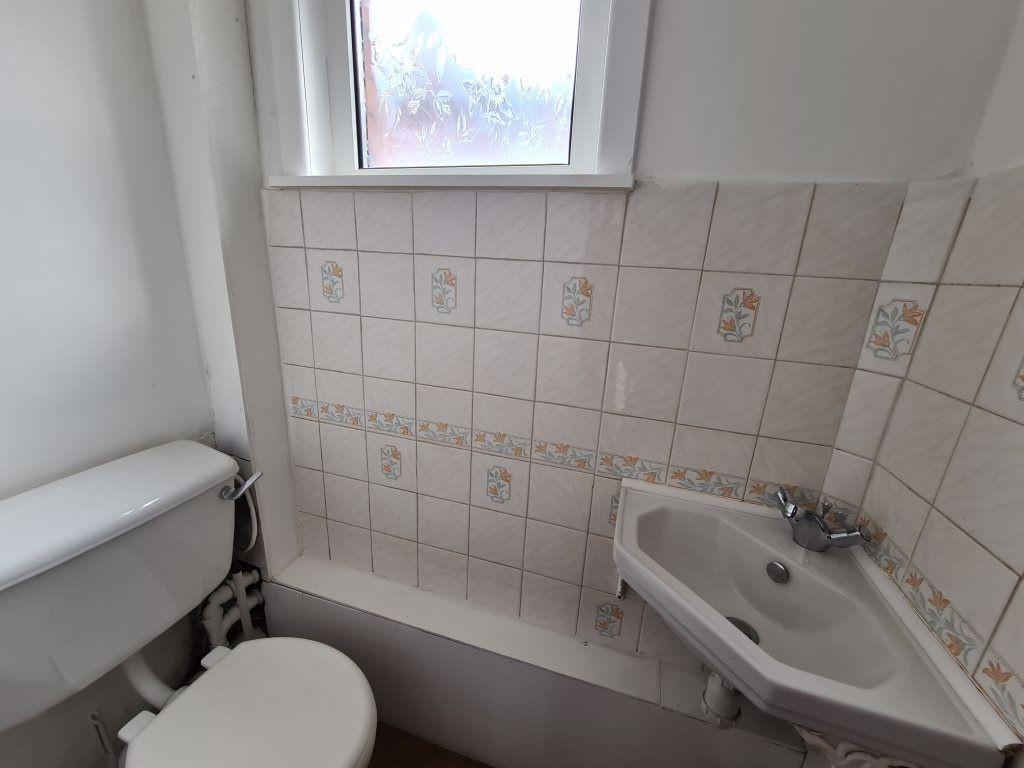 Compact and functional single toilet area featu...