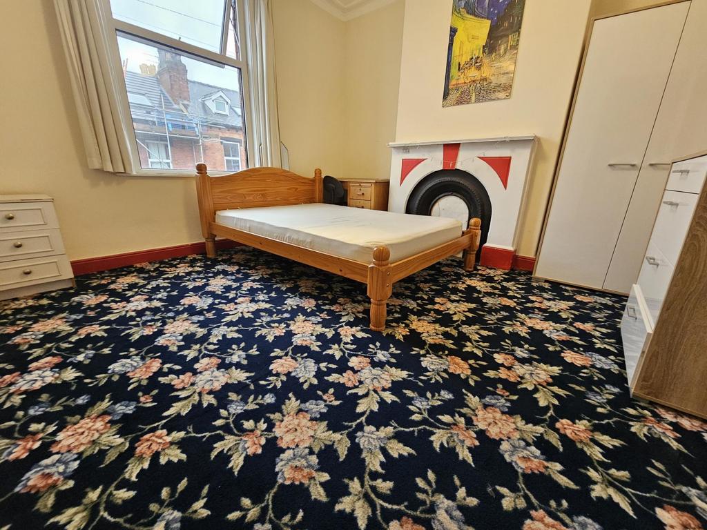 A spacious master bedroom featuring a double be...