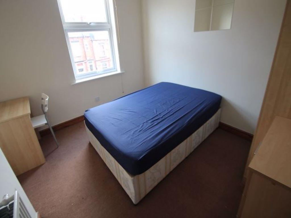 A simple and tidy double bedroom featuring a do...