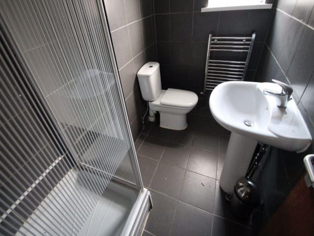 A modern bathroom suite featuring a walk-in sho...