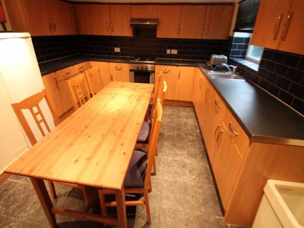 A warm and inviting kitchen featuring wooden ca...
