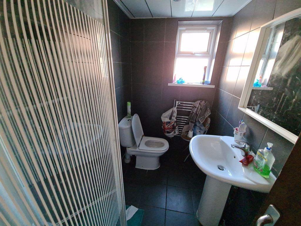 A compact, well-maintained bathroom featuring a...