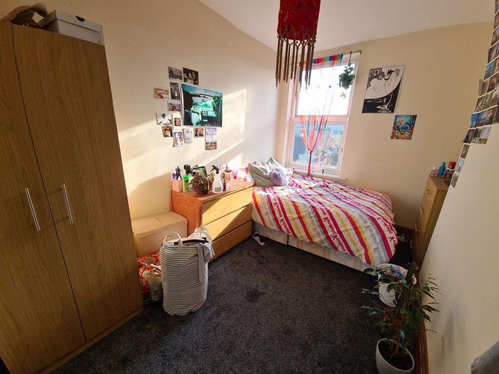 Cozy single bedroom featuring a comfortable bed...
