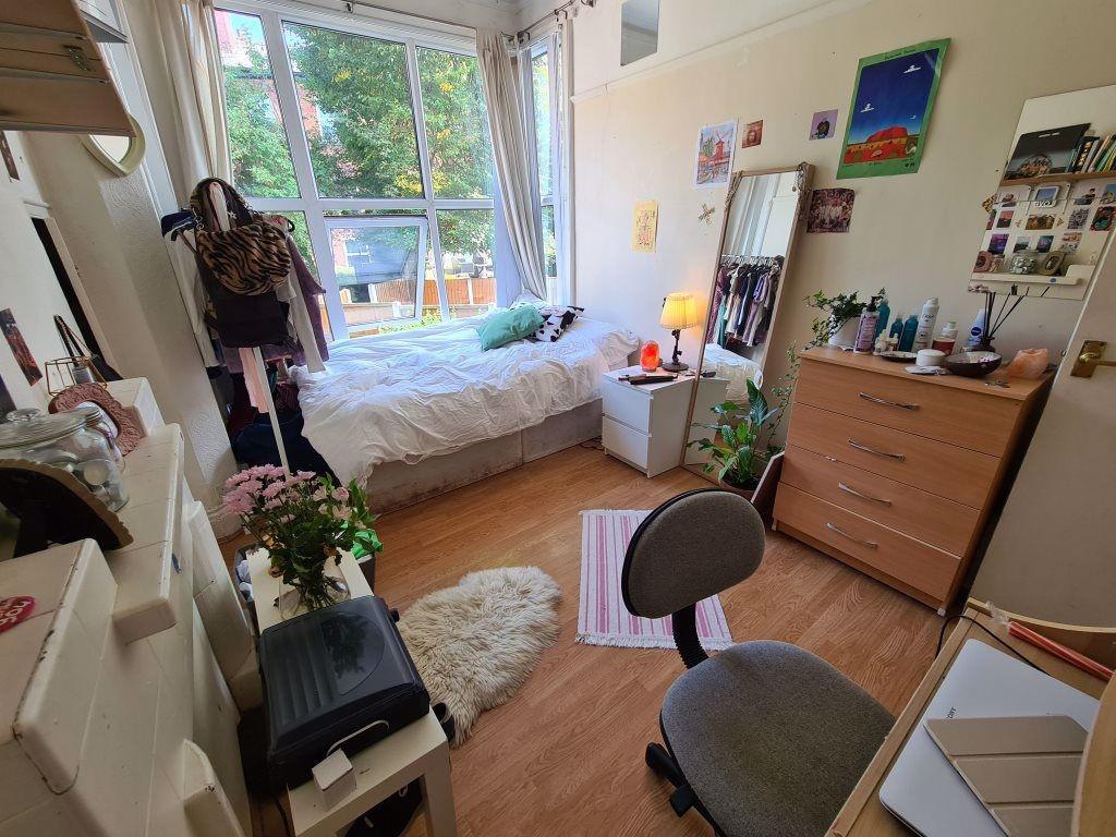 A cozy and well-lit single bedroom featuring a ...