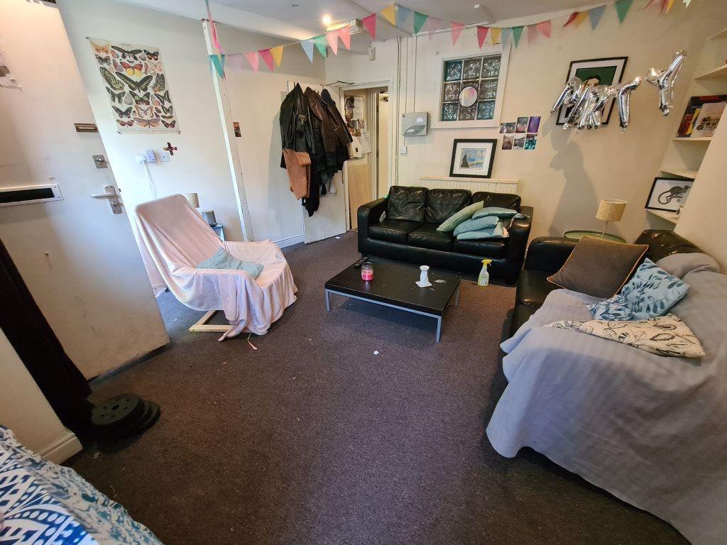 A cozy living room featuring comfortable sofas,...