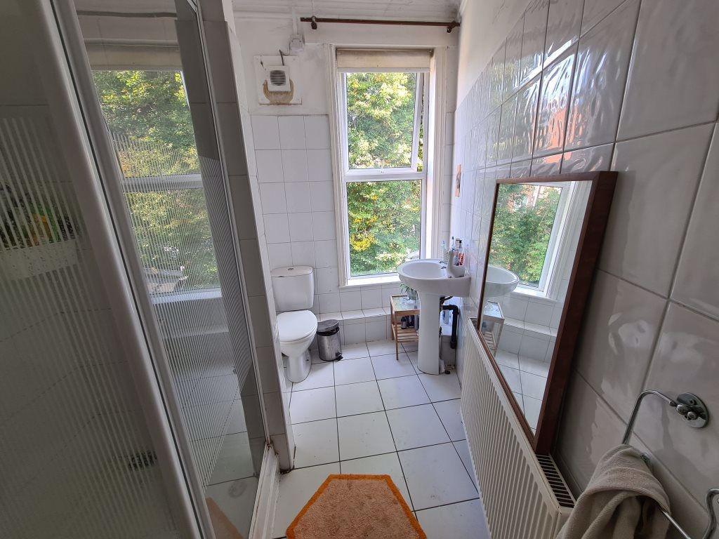 Bright and clean bathroom featuring a large win...