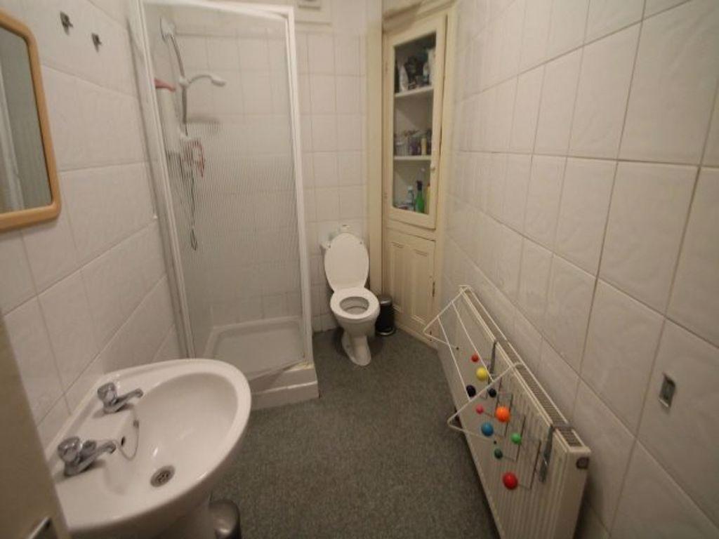 A clean and functional bathroom featuring a wal...