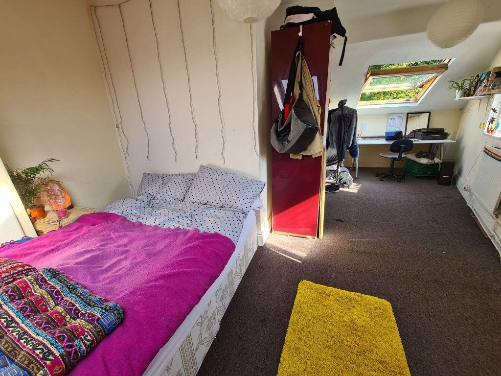 Cozy single bedroom featuring a comfortable bed...