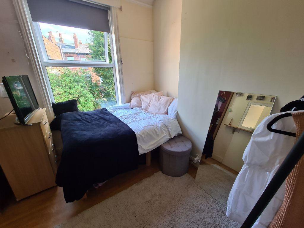 Cozy single bedroom featuring a comfortable bed...