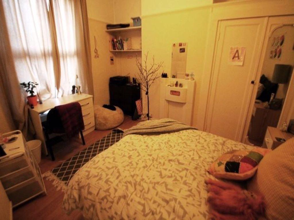 Cozy and inviting master bedroom featuring a co...