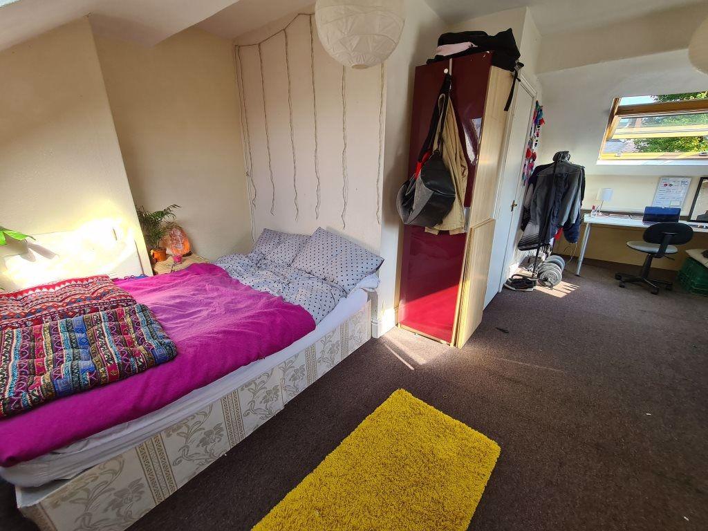 Bright and cozy master bedroom featuring a comf...