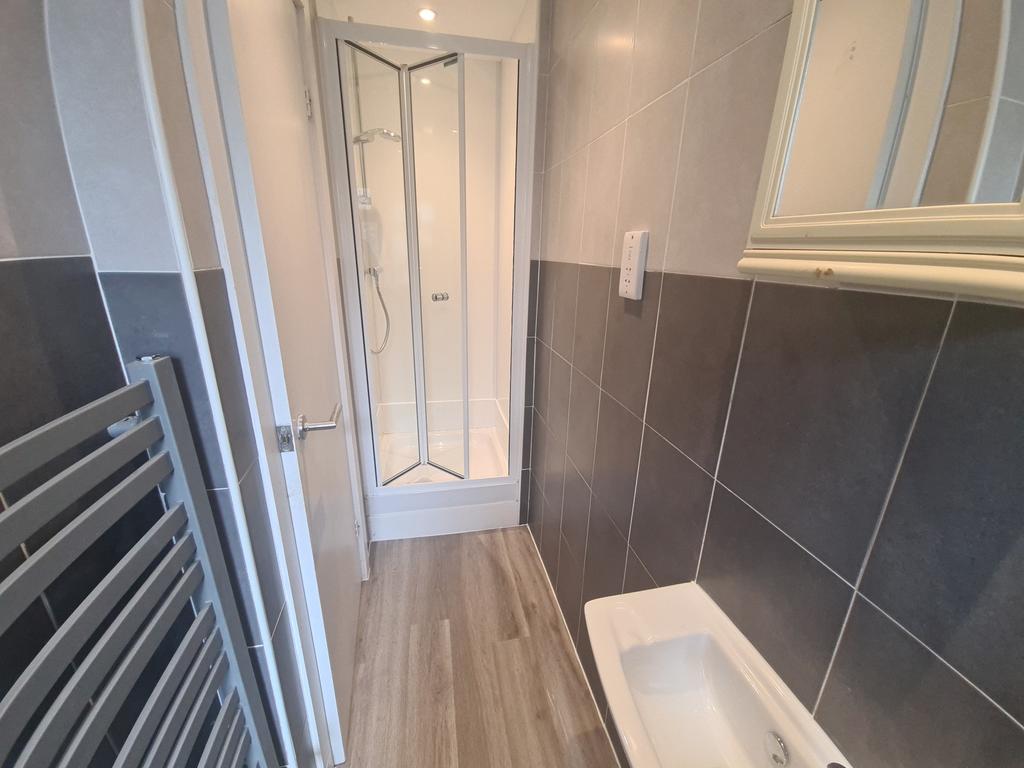 A modern bathroom featuring a sleek shower cubi...
