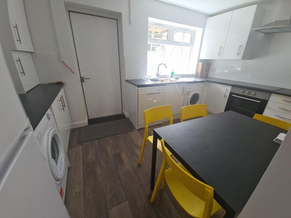 Bright and modern kitchen featuring ample count...