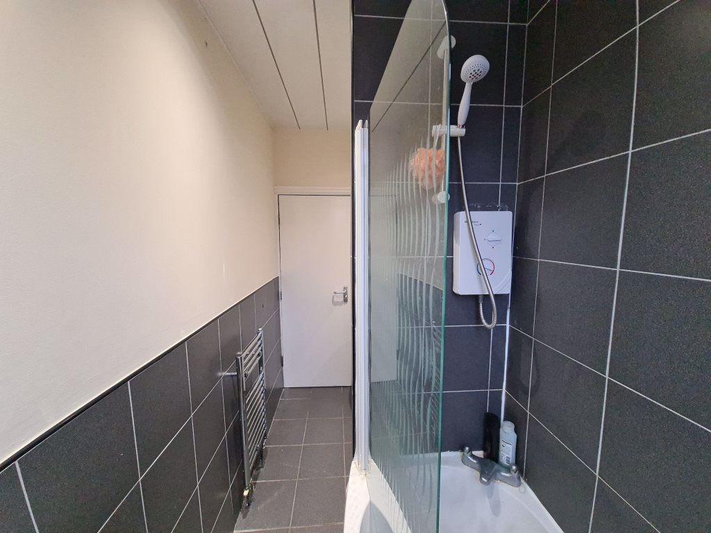 A modern bathroom featuring a tiled walk-in sho...