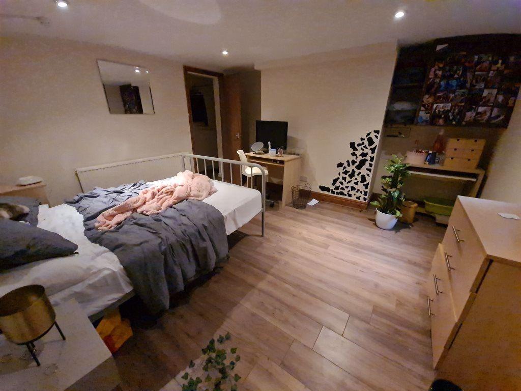 Cozy single bedroom featuring a comfortable bed...
