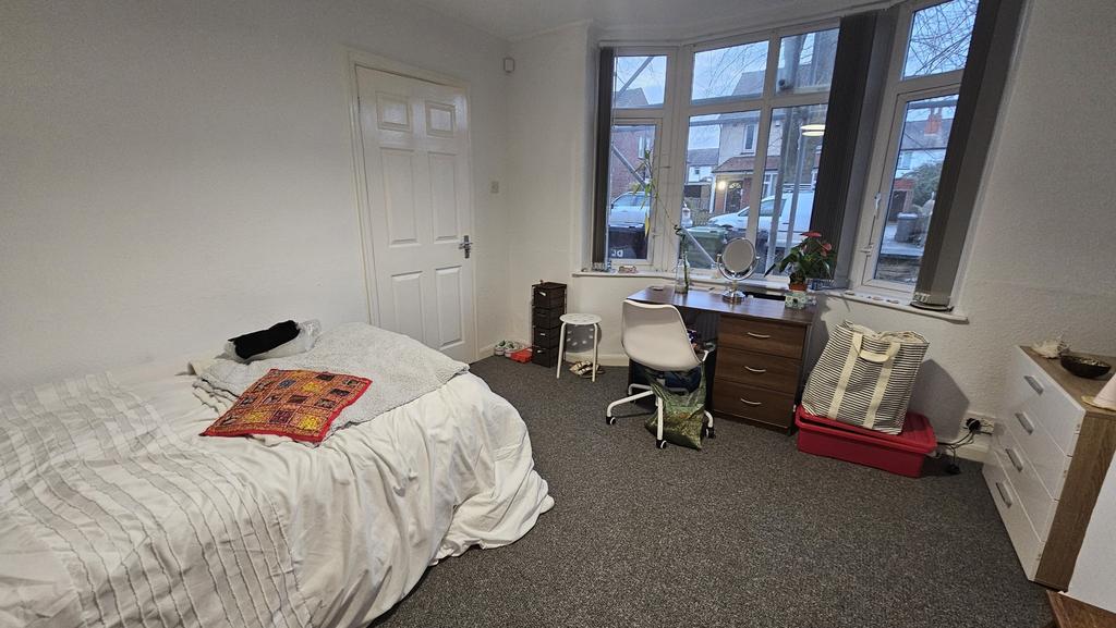 A bright and welcoming master bedroom featuring...