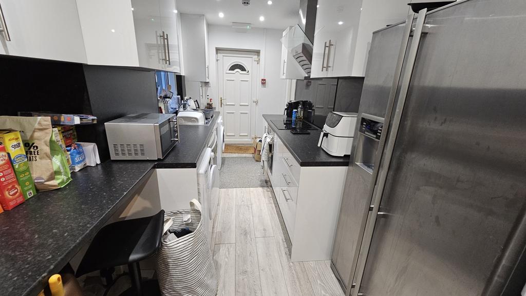 A modern, well-equipped kitchen with sleek whit...