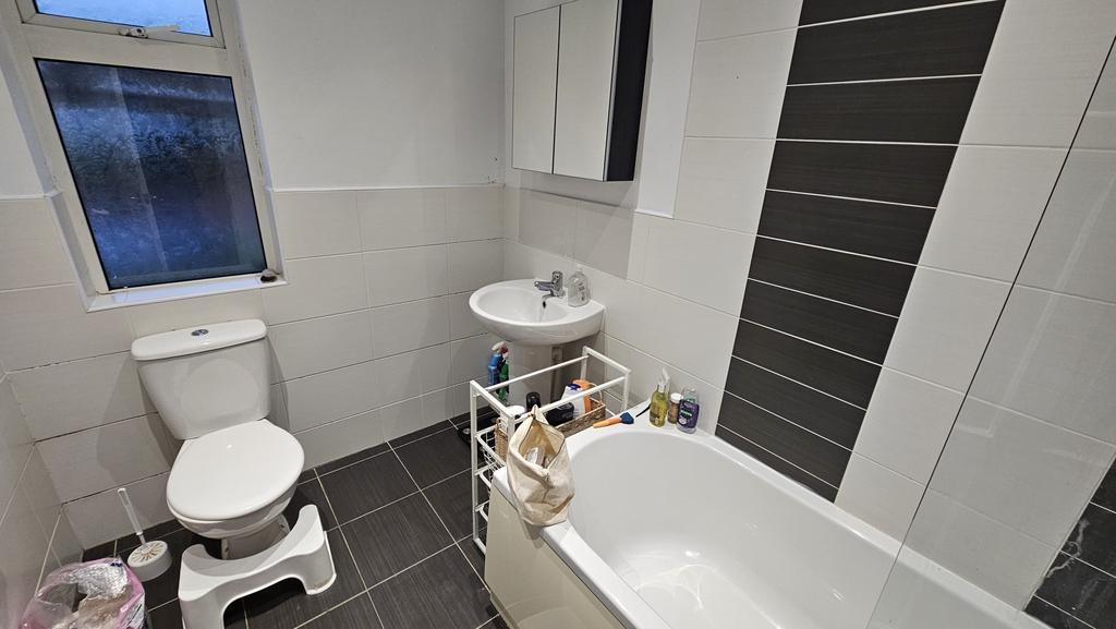 Bright and modern bathroom featuring a full bat...