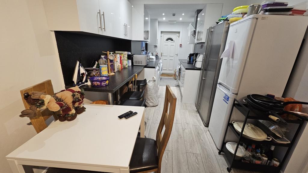 A modern, well-equipped kitchen featuring white...