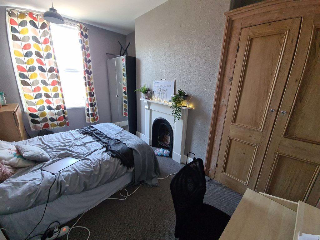 A cozy and well-lit double bedroom featuring a ...