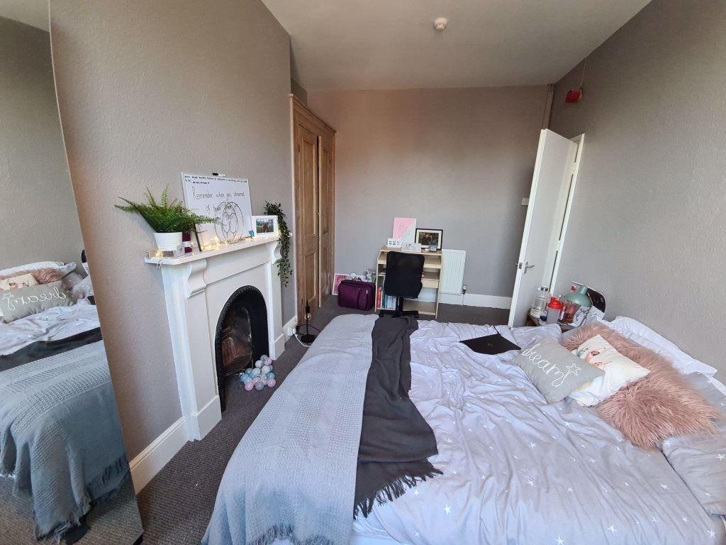 A spacious and cozy master bedroom featuring a ...