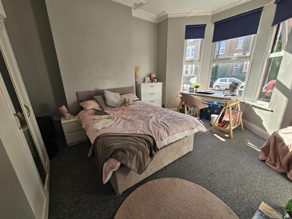 A bright and inviting master bedroom featuring ...