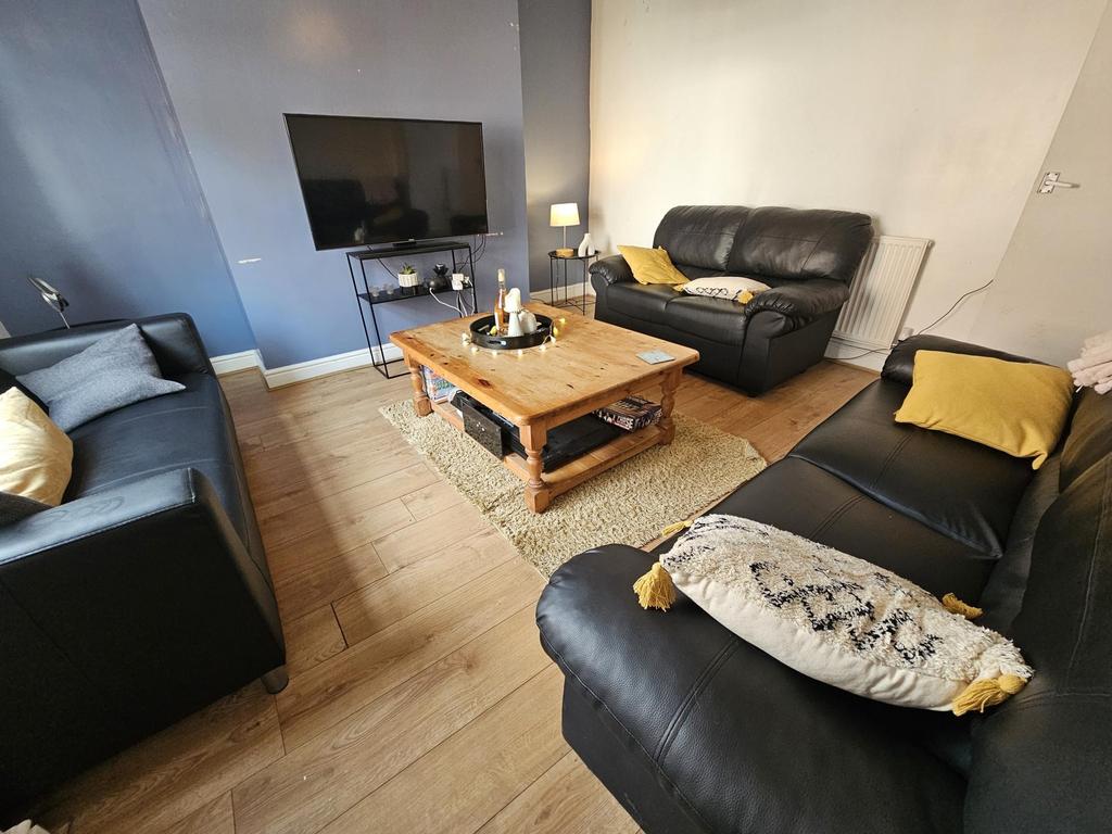 A welcoming living room featuring three black l...