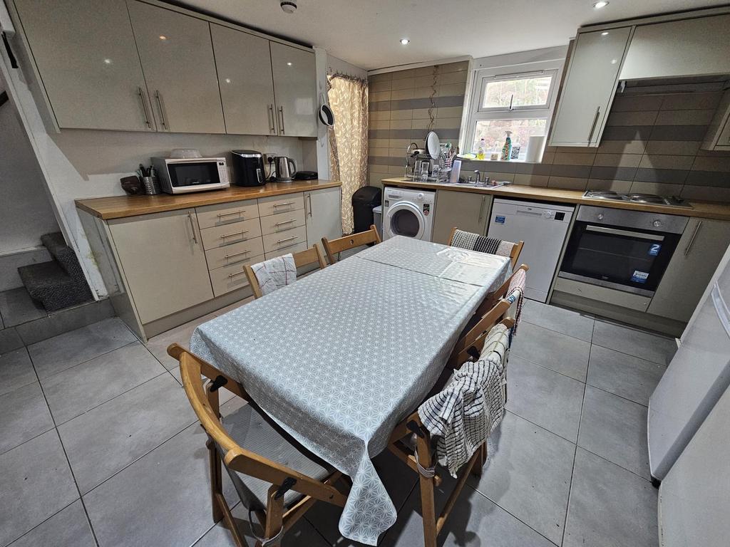 Modern kitchen with ample cabinetry, a dining t...