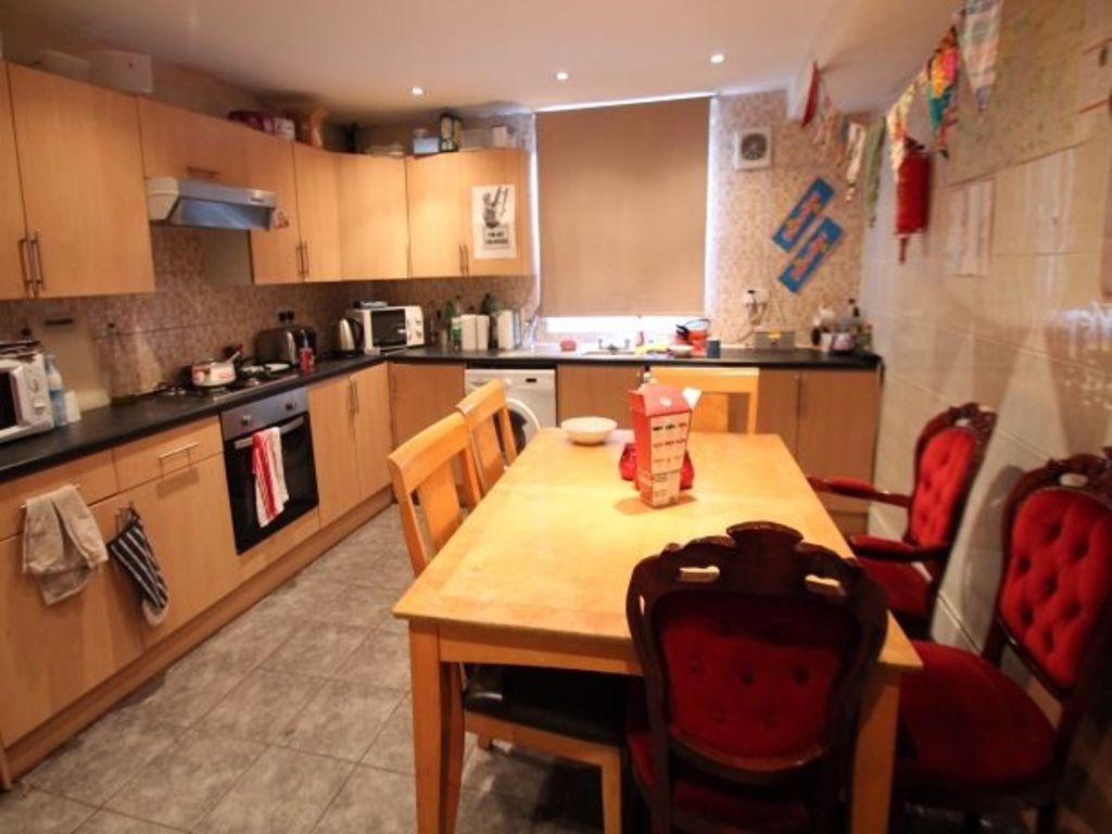 A warm and inviting kitchen featuring ample woo...