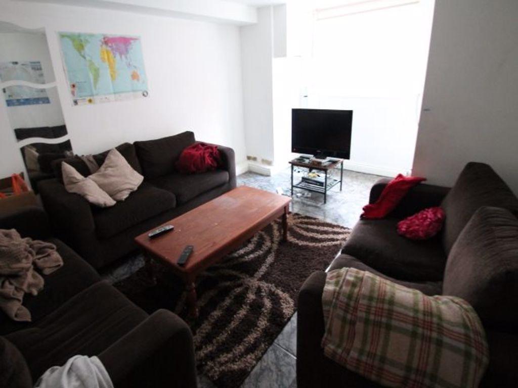 A cozy living room featuring comfortable dark s...