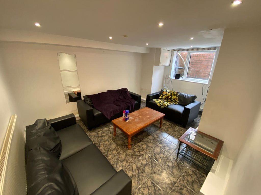 A cozy communal lounge featuring a mix of comfo...