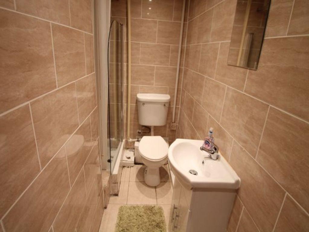 A clean and modern bathroom featuring tiled wal...