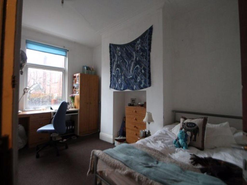 Cozy single bedroom featuring a comfortable bed...