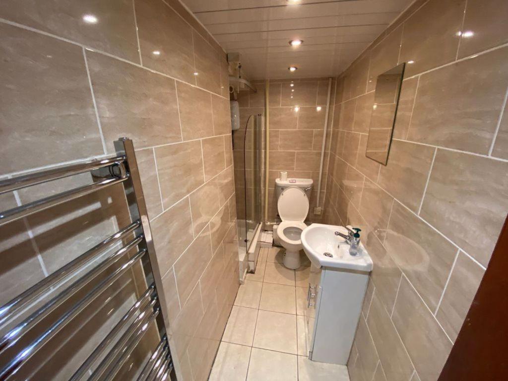 A modern bathroom featuring sleek tiled walls a...