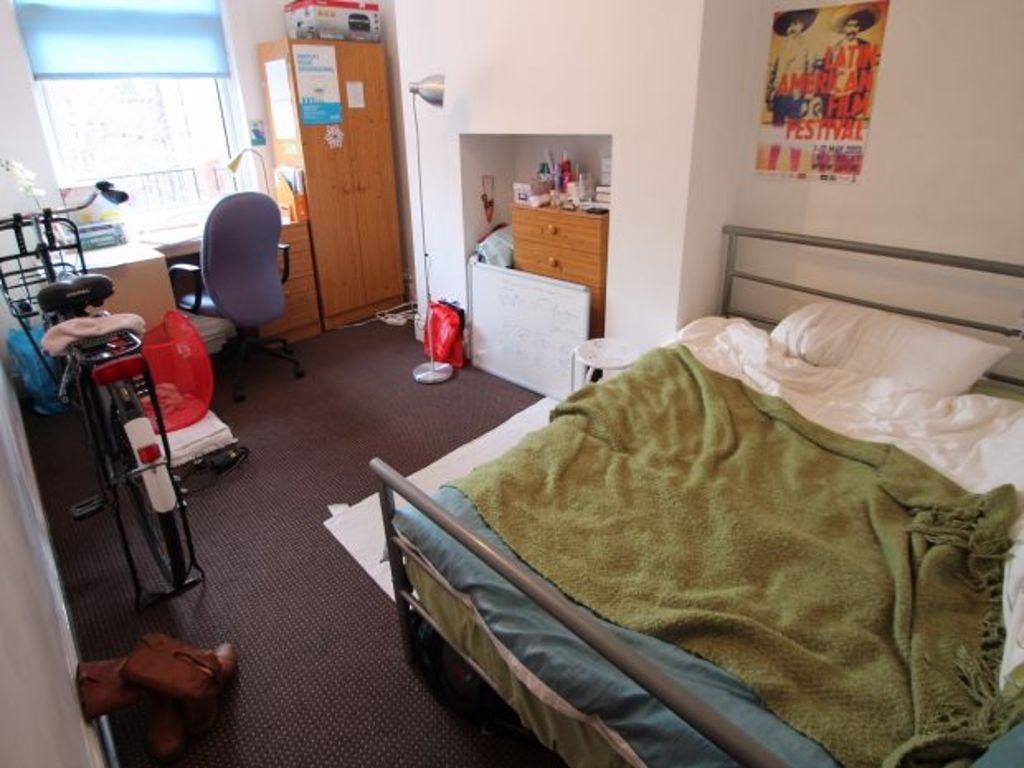 A cozy single bedroom featuring a comfortable b...