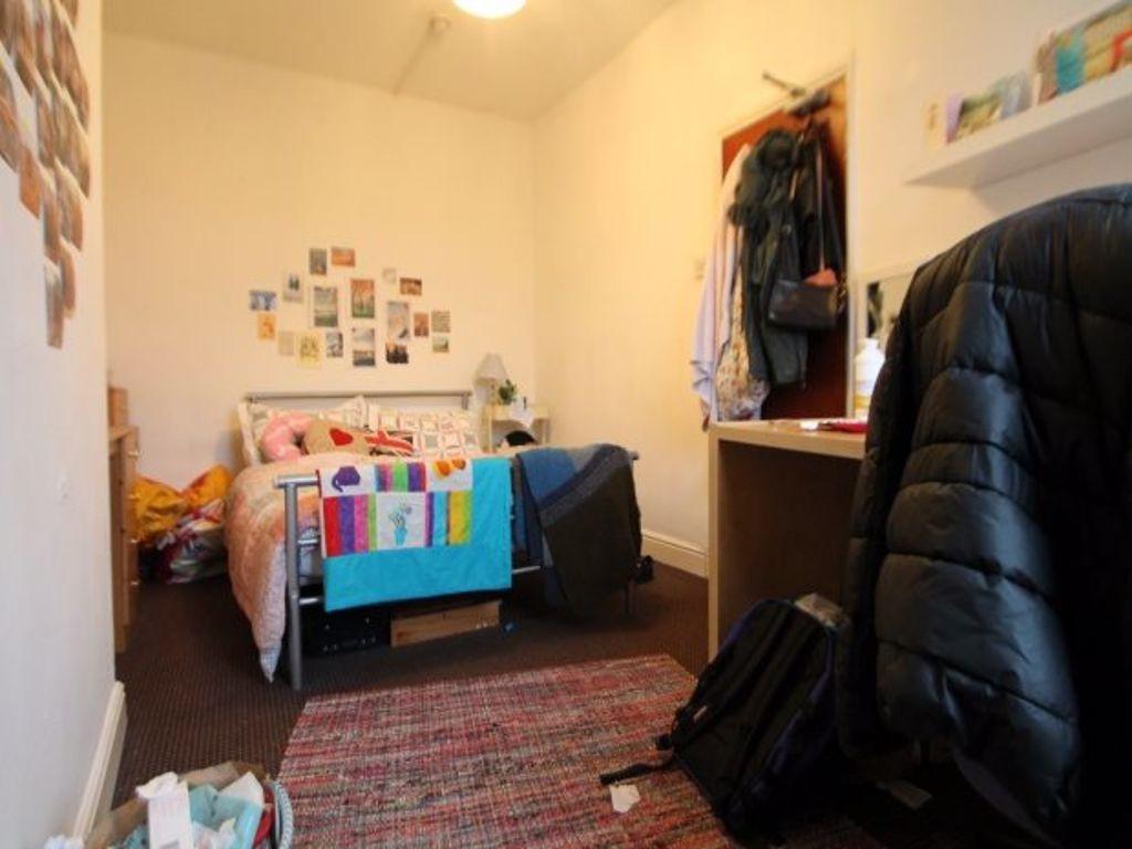 Cozy and well-kept bedroom featuring a comforta...