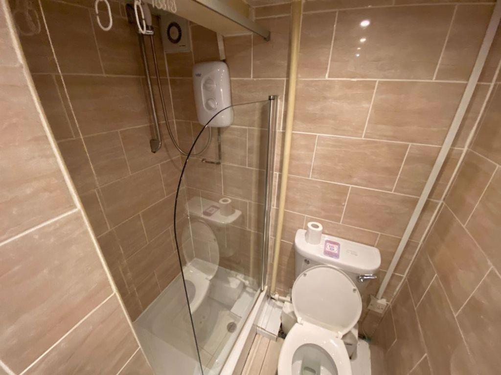 Modern bathroom featuring a clear glass shower ...