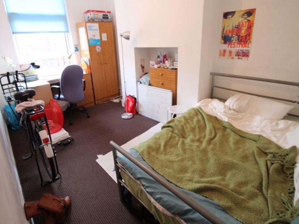 A cozy single bedroom featuring a comfortable b...