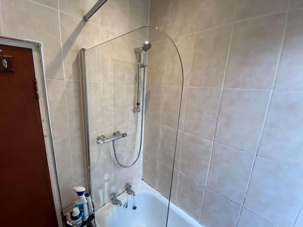 A modern bathroom suite featuring a clean white...