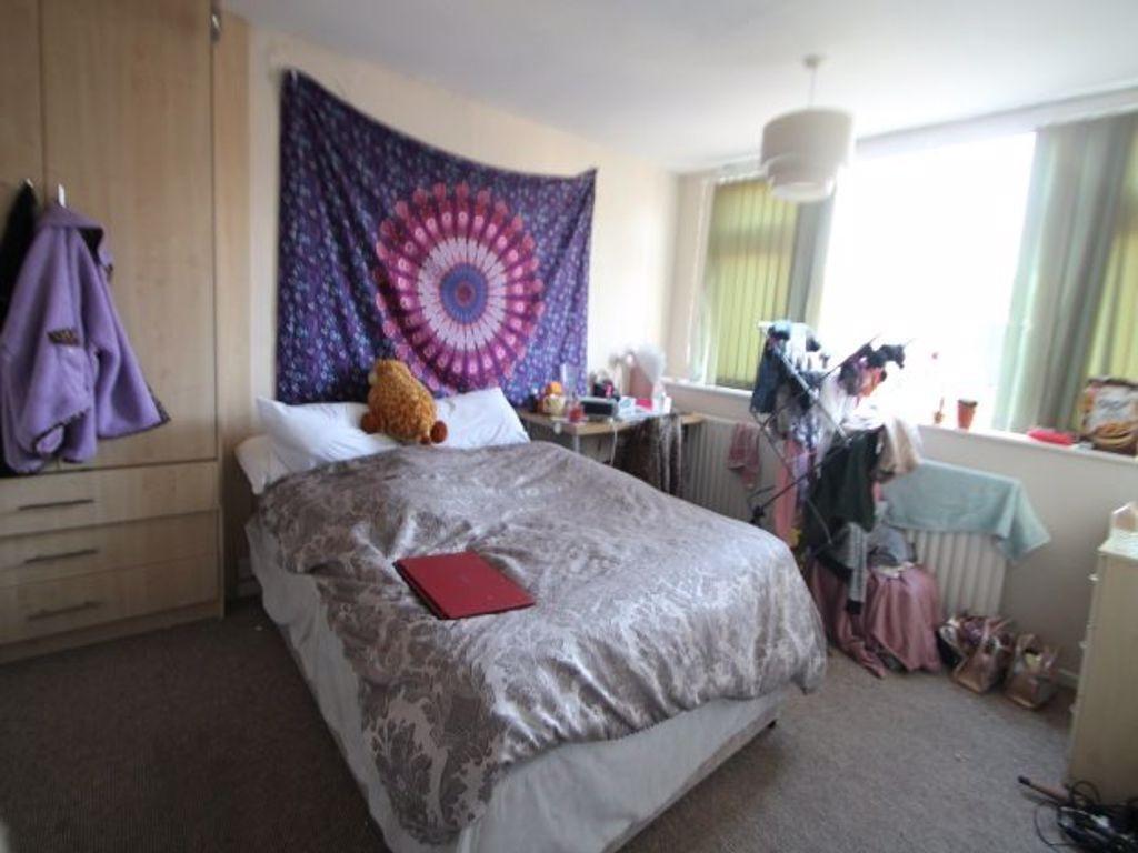 Cozy single bedroom featuring a comfortable bed...