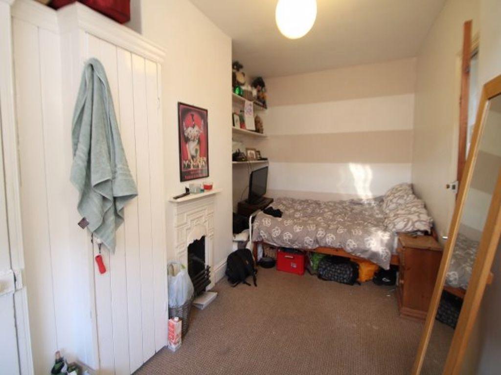 Cozy single bedroom featuring a single bed tuck...